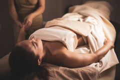 A young woman undergoes body biotherapy in an aesthetic clinic.